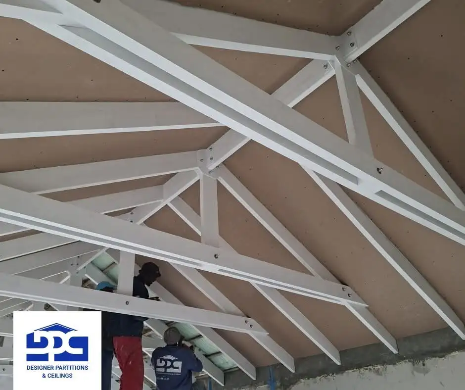 Designer Partitions & Ceilings team working on a ceiling installation
